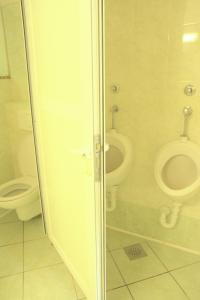 a bathroom with a toilet and a bidet at Avtokamp pri mlinu - Tent or Camper Pitch - Dujčeva domačija in Vremski Britof +8 photos