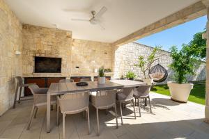 an outdoor patio with a dining table and chairs at Vila Marila in Stara Novalja