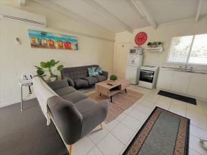 a living room with a couch and a table at Esperance Little Units 2 in Esperance