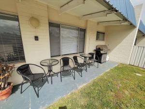 a group of tables and chairs on a patio at Esperance Little Units 2 in Esperance