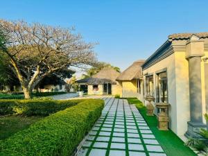 a house with a tiled walkway next to a building at Radiant Resort in Manzini