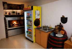 a yellow refrigerator in a kitchen with a fireplace at Rooms Ava Raj in Međugorje