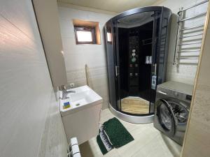 a bathroom with a sink and a washing machine at Квартира in Samarkand