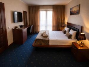 a hotel room with a bed and a desk at Porto Bistro in Baku +15 photos