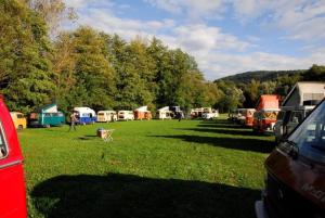 a group of tents in a field with people in the grass at Avtokamp pri mlinu - Tent or Camper Pitch - Dujčeva domačija in Vremski Britof