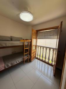 a bedroom with a bunk bed and a window at Casa en la playa con piscinas in Gran Alacant +21 photos