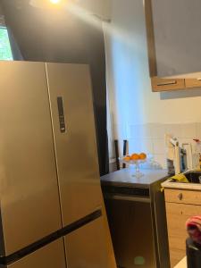 a kitchen with a stainless steel refrigerator and a counter at Faith hot in Courcouronnes