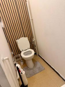 a small bathroom with a toilet in a stall at Faith hot in Courcouronnes
