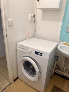 a washing machine with a pink candle on top of it at Faith hot in Courcouronnes