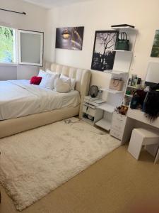a bedroom with a large bed and a desk at Faith hot in Courcouronnes