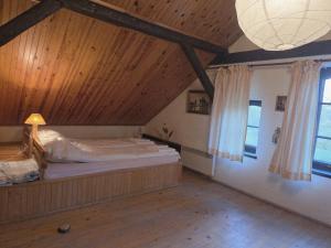 a bedroom with a large bed in a wooden ceiling at Stawy Karłowo in Karłowo