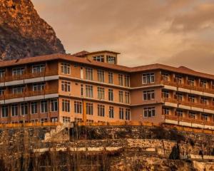 a building on the side of a mountain at Hotel Mashabrum Skardu Free Breakfast Mountain View Family Rooms & Free WiFi in Skardu