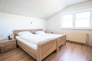 a bedroom with a large bed and a window at Ferienhaus Steinhoff in Marsberg