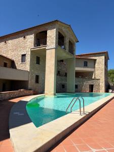 a swimming pool in front of a building at Chianti Borgo 28 in Gaiole in Chianti