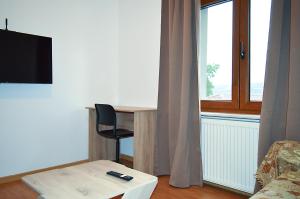 a living room with a desk and a window at D6 Lake View in Kastoria
