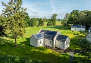 an aerial view of a house on a green field at Roxburghe Cottages, part of Destination by Hyatt in Kelso