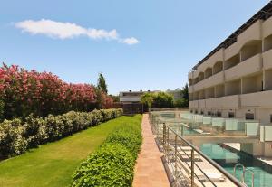 an external view of a building with a garden at Leonardo Kolymbia Resort Rhodes in Kolymbia