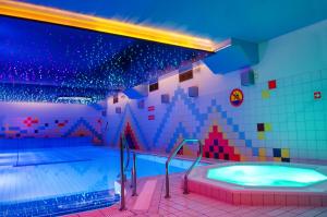 a large bathroom with a large tub in a pool at Hotel Lidia - część Economy in Darłowo