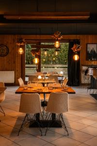 a dining room with a table and chairs at Hotel la Fontaine du Mont Blanc in Les Houches