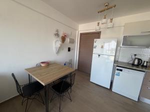 a kitchen with a table and a white refrigerator at North Residence Sea View Cozy Home in Kyrenia +24 photos