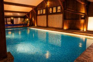a large swimming pool in a building with at Hotel la Fontaine du Mont Blanc in Les Houches