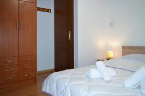 a bedroom with a white bed with white pillows at D6 Lake View in Kastoria
