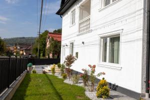a white house with plants on the side of it at Ina Deluxe in Moisei