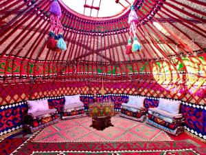 a room with a gazebo with chairs and a table at Nomad Garden Camp in Cholpon-Ata