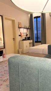 a bedroom with two beds and a couch at August in Jazan