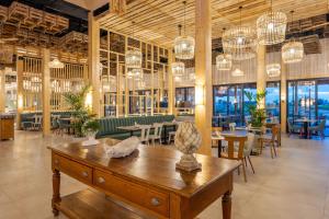 a restaurant with tables and chairs and chandeliers at Pestana Dunas All Inclusive in Porto Santo