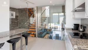 a kitchen with a living room with a blue couch at Emily in Vale do Lobo