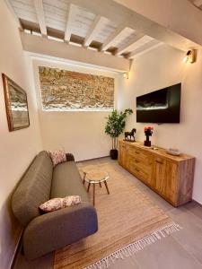 a living room with a couch and a flat screen tv at Borgo Carla in Massa