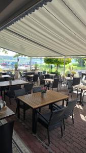 a group of tables and chairs under a canopy at Pension Seeschlösschen in Semlin