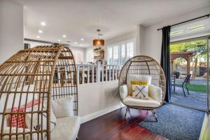 a room with two swinging cages and a chair at Luxury and Harmony in a 6BR Dream Villa; Pool, Hot Tub, Game room, Near the Las Vegas Strip in Las Vegas +112 photos