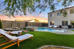 a backyard with a swimming pool and a house at Luxury and Harmony in a 6BR Dream Villa; Pool, Hot Tub, Game room, Near the Las Vegas Strip in Las Vegas