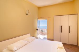 a bedroom with a bed and a door to a balcony at Apartments Amaris in Promajna