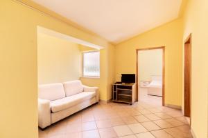 a living room with a couch and a television at Apartments Amaris in Promajna +68 photos