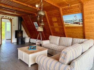 a living room with a couch and a table at Ferienhaus Seemöwe in Damp