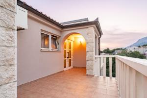 a house with a balcony with a view at Apartments Amaris in Promajna