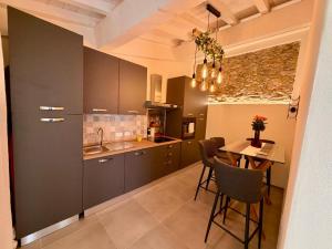 a kitchen with gray cabinets and a table with chairs at Borgo Carla in Massa