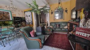 a living room with couches and chairs in a room at Clos Germanois entre Clermont, Lyon ,St Etienne A89 sortie 32 in Saint-Germain-Laval