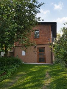a brick house with a door and a yard at Broumík - chata s výhledy in Opočno