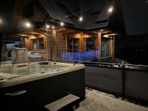 a jacuzzi tub in the middle of a house at Domek Pod Wierchami z Jacuzzi in Kościelisko