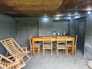 a wooden table and chairs in a room at Mtisani in Roshka +7 photos