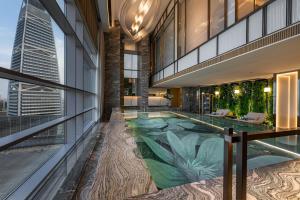 an indoor pool in the middle of a building at Narcissus The Royal Hotel in Riyadh
