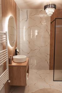 a bathroom with a sink and a large stone wall at Ina Deluxe in Moisei +57 photos