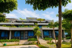 an office building with plants on the facade at Samara Villa by Sinergi in Tawangmangu