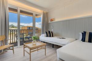 a hotel room with two beds and a balcony at Pestana Dunas All Inclusive in Porto Santo