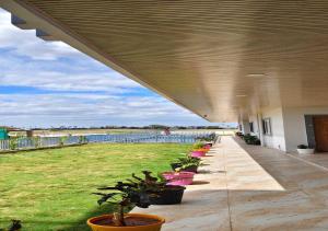a building with a row of potted plants on a patio at S R RESORTS in Chīrāla