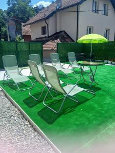 a group of chairs and a table with an umbrella at Apartman Dunja 2 in Bajina Bašta